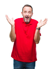 Middle age hoary senior man over isolated background clueless and confused expression with arms and...