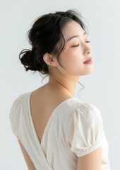 Fototapeta premium An Asian woman showcasing her back portrait adult white.