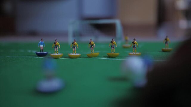 playing classic table football game making goal slow motion