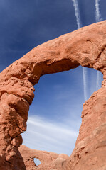 Turret Arch frames North Window Arch. Unrecognizable people on North Window Arch. Arches National Park. Utah. © Janice