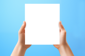 Hands holding blank card paper sheet isolated on blue background with copy space. Generative AI.