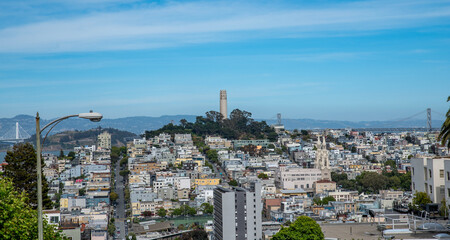 Coit Tower on Telegraph Hill aerial overlooking San Francisco Bay with houses and apartments