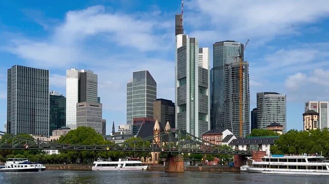 Embankment Main river view of Iron Bridge and skyscrapers of business center Frankfurt am Main, Germany, Europe August 8, 2024. High quality 4k footage