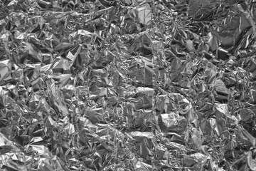 Processed collage of shiny metal silver gray foil crumpled packaging material texture