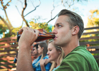 Naklejka premium Man, beer and friends outdoor of home on patio with drinks, bottle and labor day fun at party. Summer, backyard and together with alcohol, conversation and joke at group reunion and social event