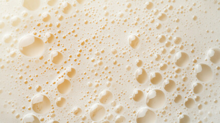 Top view of a milkshake or cocktail foam with bubbles, showcasing its texture or background.