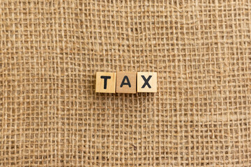 Tax Concept on Wooden Blocks with Burlap Background