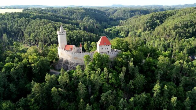 Aerial footage of Kokorin Castle nestled in lush forests in Kokorin village, Czech Republic