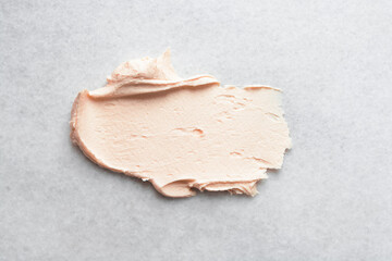 Top view of orange buttercream for decorating cake, silky smooth peach color american buttercream on a marble surface, overhead view of smooth light orange buttercream