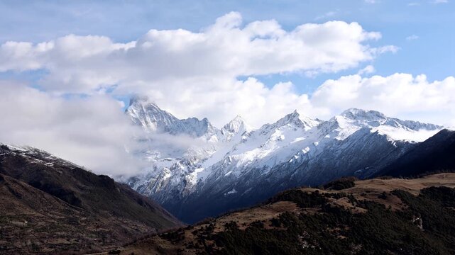 Timelapse panoramic view of Mount Siguniang of Four sisters mountain with moving clouds in Sichuan China, featuring the four peaks with Yaomei feng the tallest