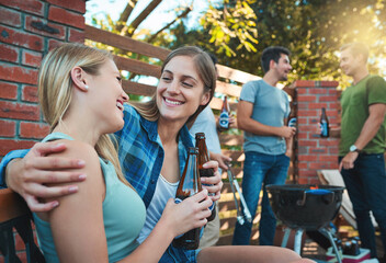Happy, talk and couple of friends in backyard for party and social event with women and drinks on patio. Outdoor, alcohol and funny joke with love, bonding and conversation at reunion with smile