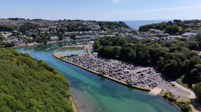 Aerial footage of Millpool Car Park and Mill Pool on West Looe River in Looe, Cornwall, England, UK