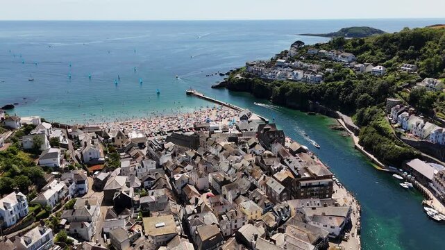 Aerial footage of the cityscape of Looe on a sunny day in south-east Cornwall, England, UK