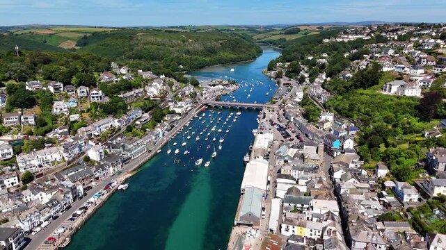 Aerial footage of the Looe harbour and the buildings on the East Looe River in Cornwall, England, UK