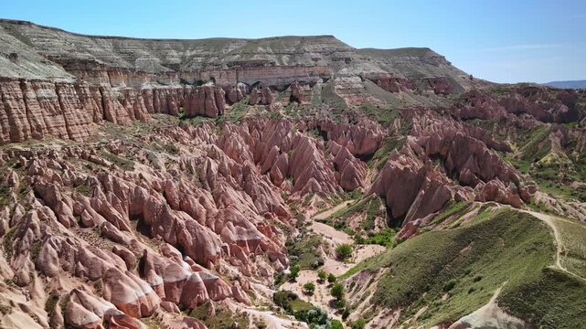 Aerial footage of the scenic Rose Valley on a sunny day in Cappadocia, Turkiye