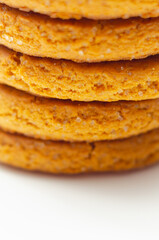 A stack of yellow cookies with a white background