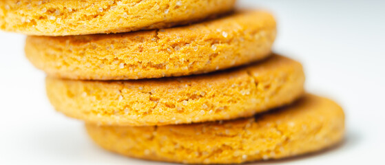A stack of yellow cookies with a white background