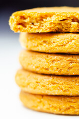 A stack of yellow cookies with a white background
