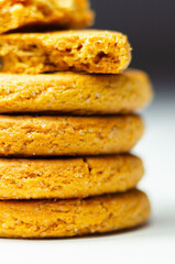 A stack of yellow cookies with a white background