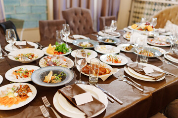 a large served festive table with appetizers. catering services for a holiday at home. 