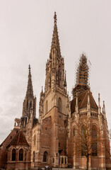 Fototapeta premium Ulm Minster, Cathedral of Ulm city, Germany. Ulmer or Munster on German is famous landmark of Ulm. Panorama of ornate facade of Gothic church in summer. Nice scenery of medieval European architecture