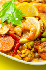 A plate of food with shrimp, peppers, and rice