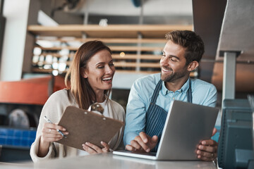 Small business, happy and couple in cafe with laptop, positive review and pride for turnover...