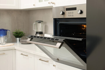 Fototapeta premium Open electric oven in kitchen. Cooking appliance
