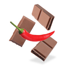 Pieces of chocolate and chili pepper in air on white background