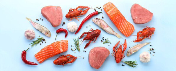 Many different fresh sea food on light blue table, flat lay. Banner design