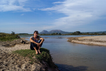 Girl and dog on the shore of the river delta, river Ter, Costa Brava, Catalonia, Spain