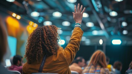 Enthusiastic participants raise their hands, eager to contribute during an inspiring session at the event