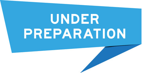 Blue color speech banner with word under preparation on white background