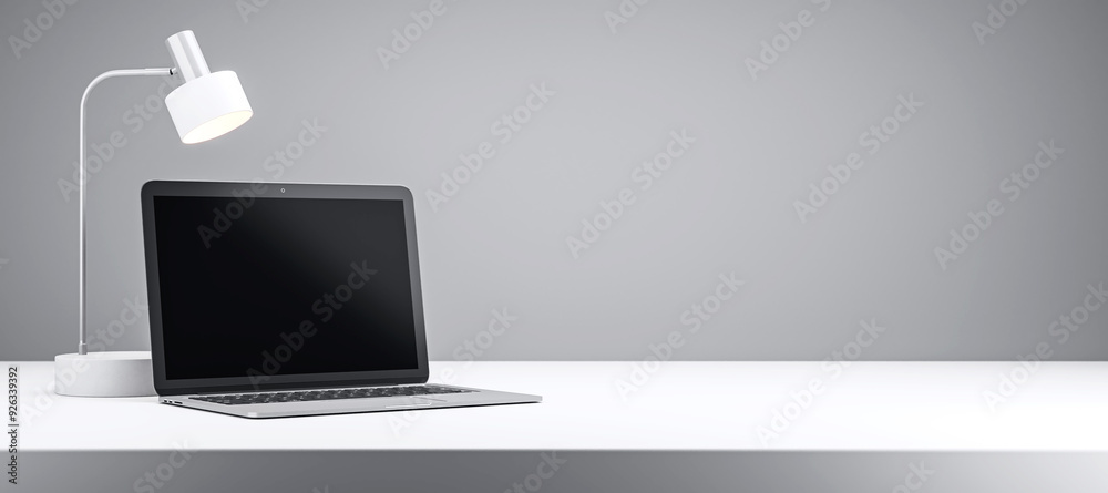 Wall mural Laptop and desk lamp on a white desk with grey background. 3D Rendering