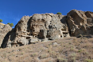 Caves in the Risco de las Cuevas, Perales de Tajuña, Spain, ancient dwellings and storage spaces from the Roman and Medieval periods carved into the earth