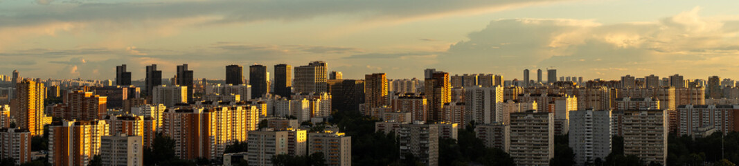 A large city at sunset, a view from above, many multi-storey residential buildings. District of Moscow. High quality photo