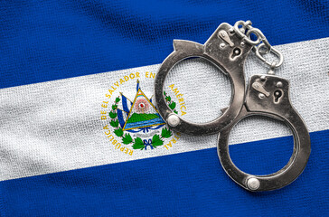  Flag of El Salvador and police handcuffs. Crime and offenses in country Concept 