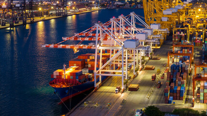 Fototapeta premium crane loading cargo container from truck to container ship in the international terminal logistic sea port concept freight shipping by ship. industry transportaion