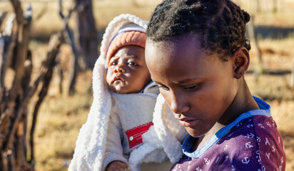 village african people, young girl holding a baby, unwanted teenage pregnancy, braided hair