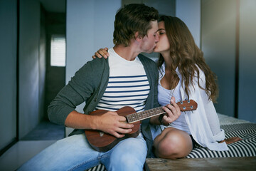 Kiss, couple and guitar in bedroom with love for partner, emotional connection and romantic gesture for affection. Woman, man and ukulele in home for playing music or song, commitment and trust.
