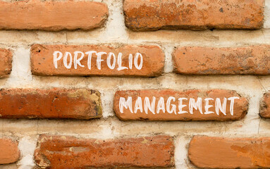 Portfolio management symbol. Concept words Portfolio management on beautiful brick wall. Beautiful red brown brick wall background. Business Portfolio management concept. Copy space.