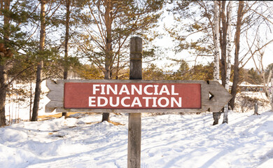 Financial education symbol. Concept words Financial education on beautiful wooden road sign. Beautiful winter forest snow tree background. Business Financial education concept. Copy space.