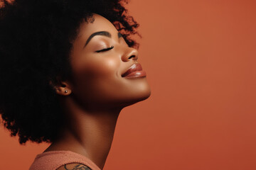 A close up of a tattooed black woman's face with her eyes closed