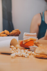 fast food, people and unhealthy eating concept - close up of woman hands holding hamburger or cheeseburger
