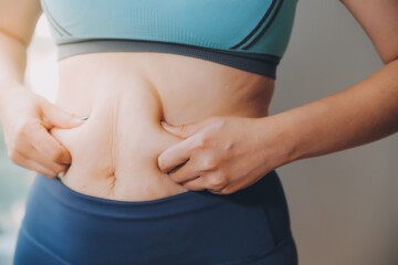 fat woman, fat belly, chubby, obese woman hand holding excessive belly fat with measure tape, woman diet lifestyle concept