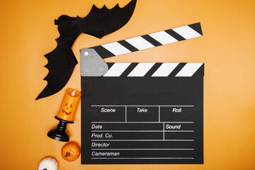Halloween movie decorations, dark cinema clapperboard, scary entertainment.