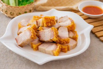 Crispy pork belly on white plate and dipping sauce