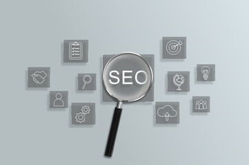 Magnifying glass focus to SEO search engine optimization for promoting ranking traffic on a website and optimizing your website to rank in search engines.