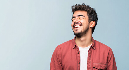 Obraz premium A happy adult Hispanic man looking away with a confident smile on his face.