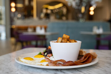 Breakfast plate with egg and bacon.